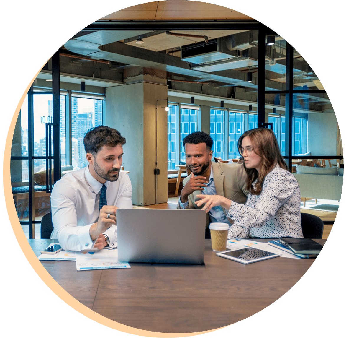 Three colleagues collaborating in modern office.