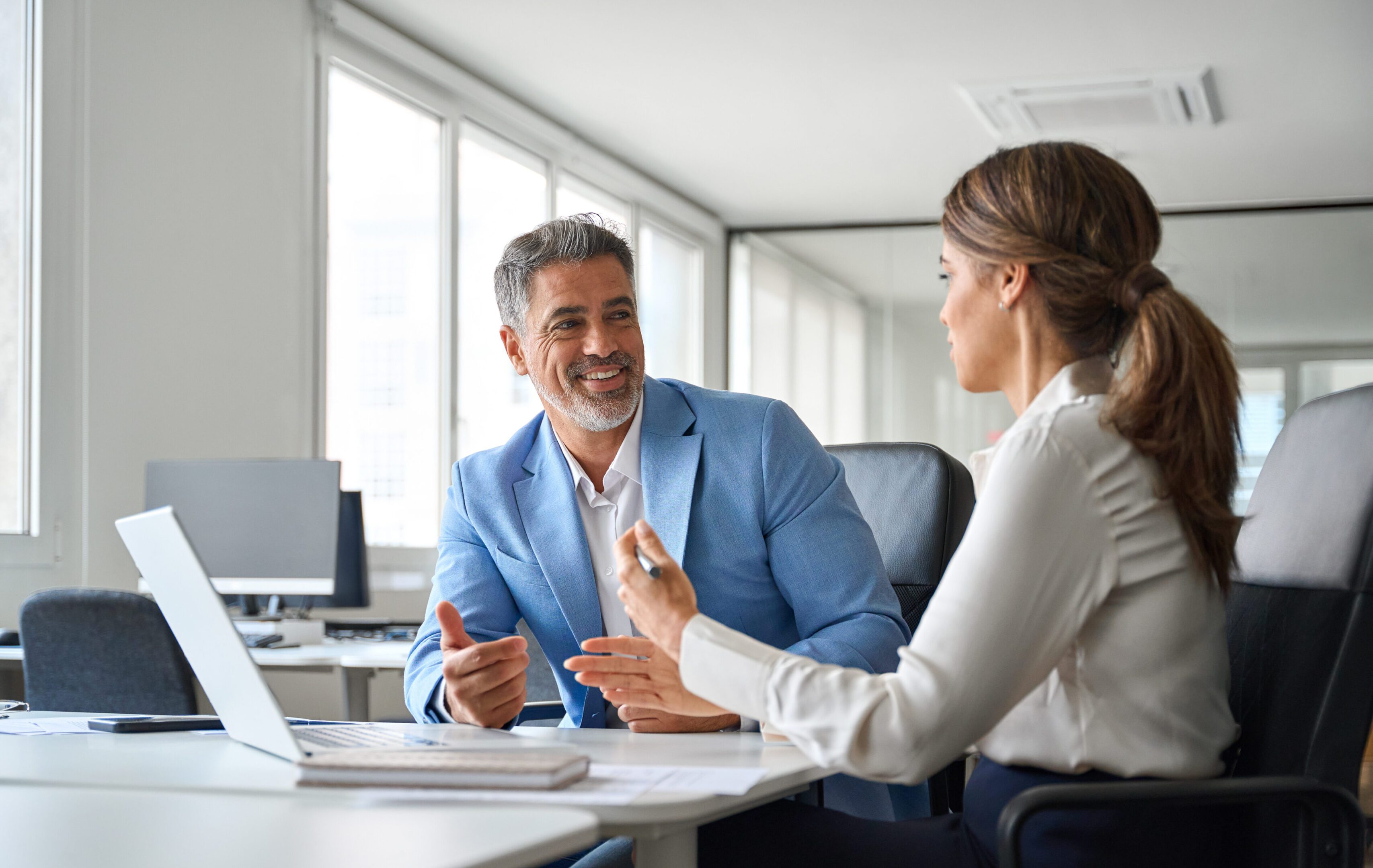 Two colleagues having a discussion in office.