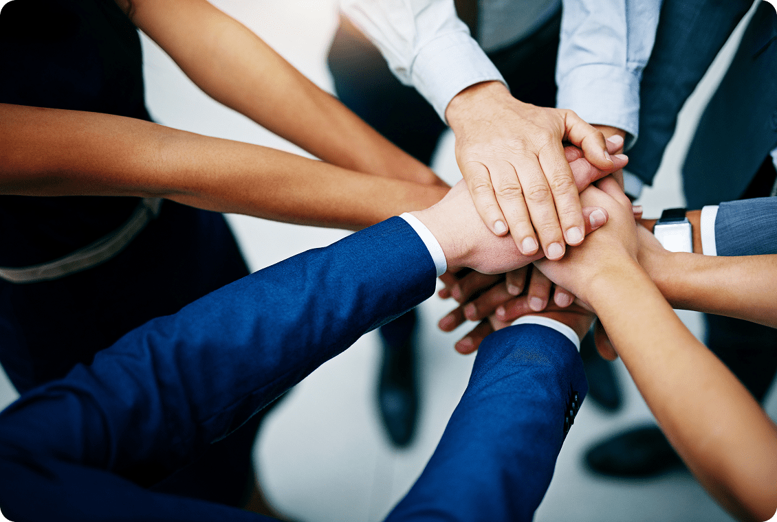 Hands joined in teamwork and unity.